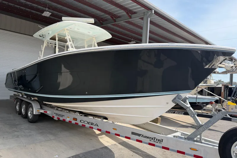 Slide: The Image of 2015 Cobia 344 Center Console boat on trailer in covered storage area. - 4