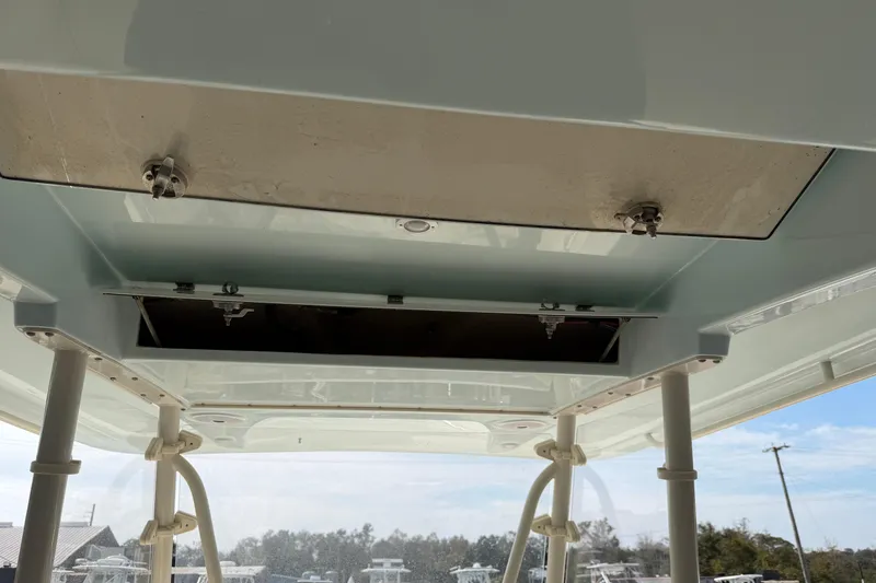 Slide: The Image of 2015 Cobia 344 Center Console boat interior ceiling view with open storage compartments. - 41
