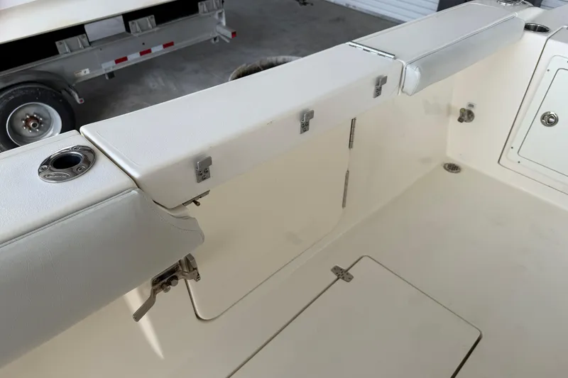 Slide: The Image of 2015 Cobia 344 Center Console boat interior with storage compartments and rod holders. - 42