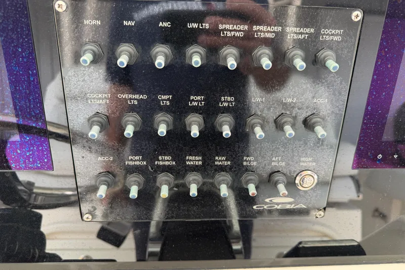 Slide: The Image of Control panel of a 2015 Cobia 344 Center Console boat with various switches. - 45