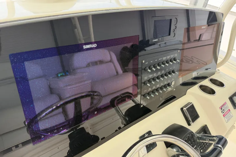 Slide: The Image of 2015 Cobia 344 Center Console dashboard with Simrad displays and control panel. - 46