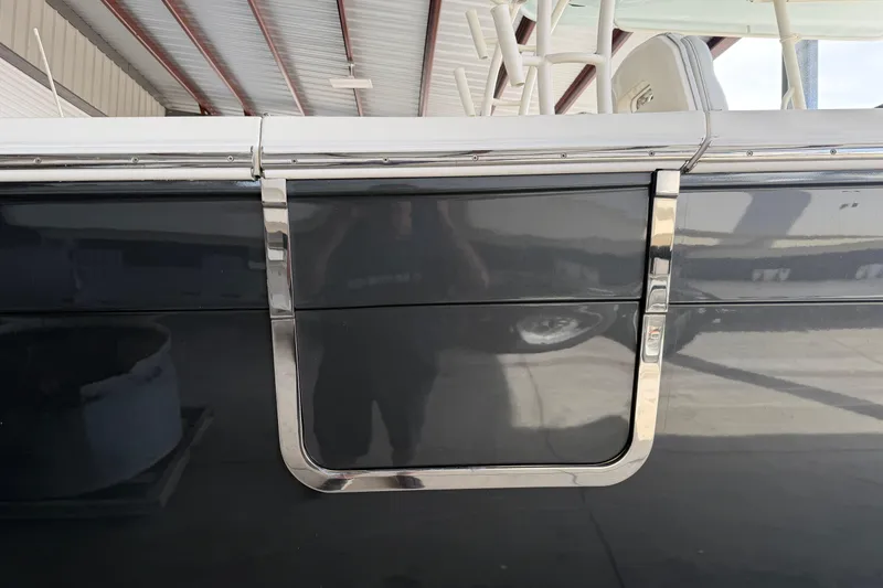 Slide: The Image of 2015 Cobia 344 Center Console boat detail with sleek chrome accents. - 5