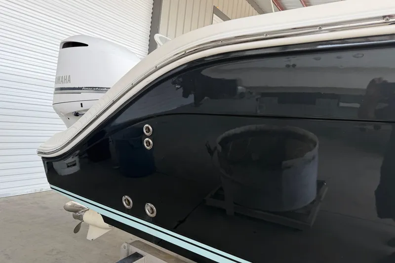 Slide: The Image of 2015 Cobia 344 Center Console boat with Yamaha engine in a garage. - 6