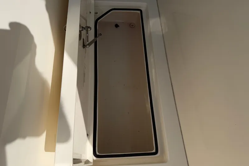 Slide: The Image of Open storage compartment on 2015 Cobia 344 Center Console boat. - 60
