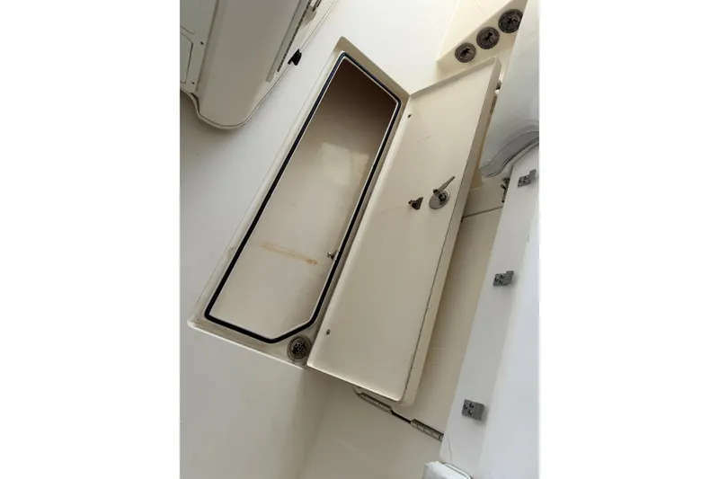 Slide: The Image of 2015 Cobia 344 Center Console storage compartment with open hatch and secure lock. - 61