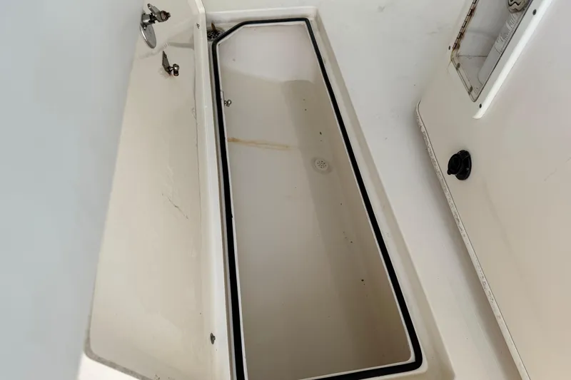 Slide: The Image of 2015 Cobia 344 Center Console storage compartment interior view. - 62