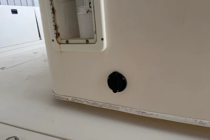 Slide: The Image of 2015 Cobia 344 Center Console boat detail with control knob and compartment. - 64