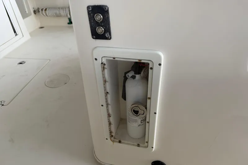 Slide: The Image of Fire extinguisher compartment on 2015 Cobia 344 Center Console boat. - 65