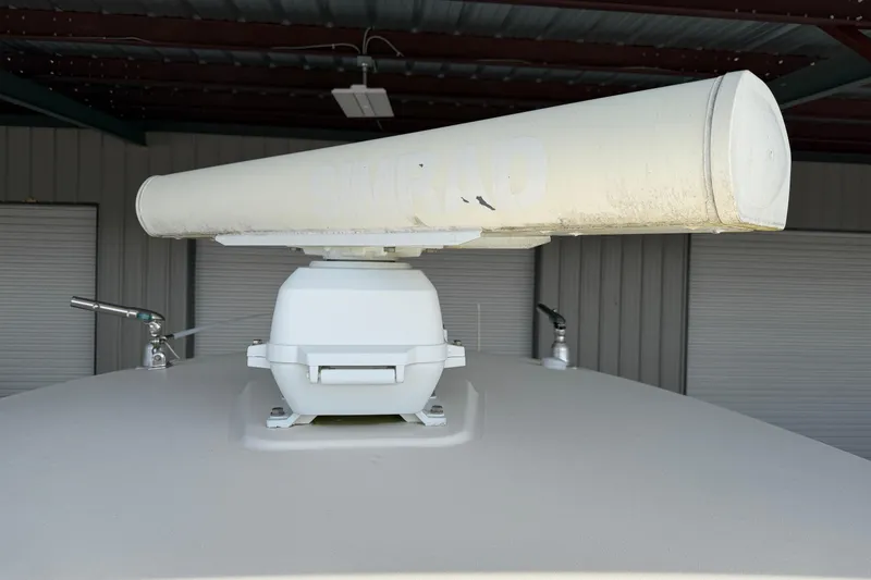 Slide: The Image of Radar equipment on a 2015 Cobia 344 Center Console boat under a metal roof. - 67