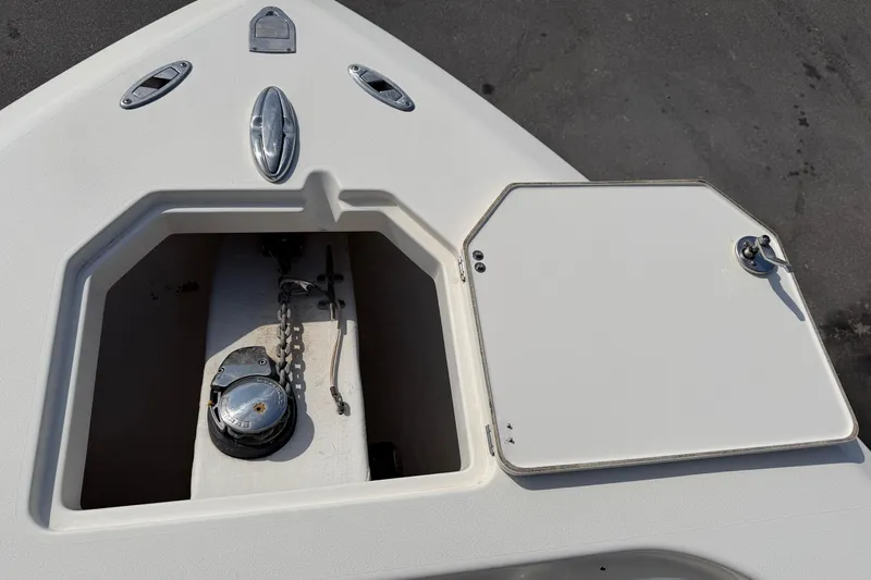 Slide: The Image of 2015 Cobia 344 Center Console boat anchor compartment with chain and hatch. - 74