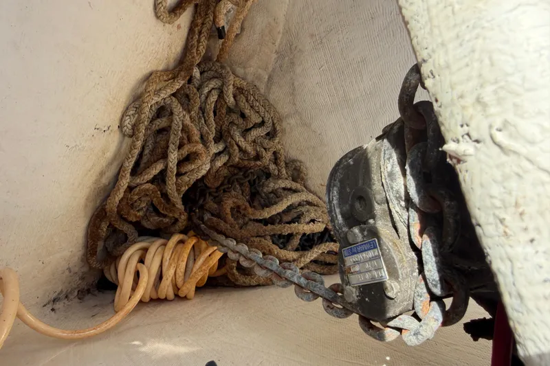 Slide: The Image of Tangled ropes and anchor chain in a 2015 Cobia 344 Center Console boat. - 76