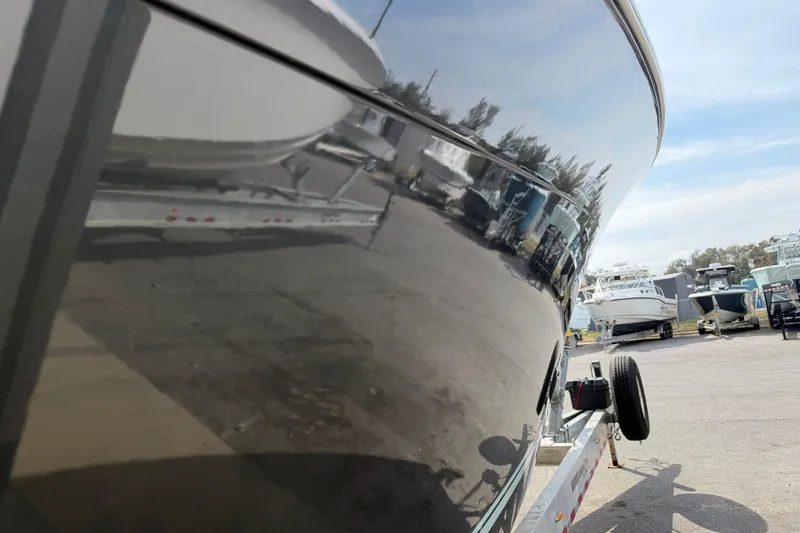 Slide: The Image of 2015 Cobia 344 Center Console boat on trailer, reflecting surroundings. - 8