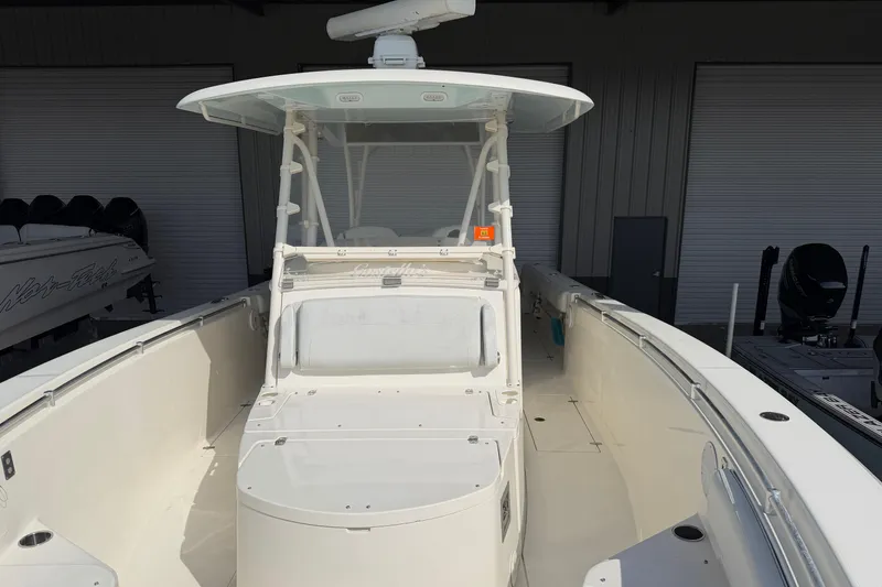 Slide: The Image of 2015 Cobia 344 Center Console boat in storage, showcasing spacious deck and helm. - 80