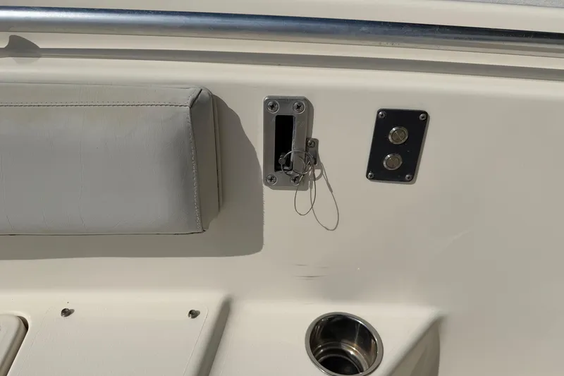 Slide: The Image of 2015 Cobia 344 Center Console boat interior with seat, cup holder, and controls. - 87