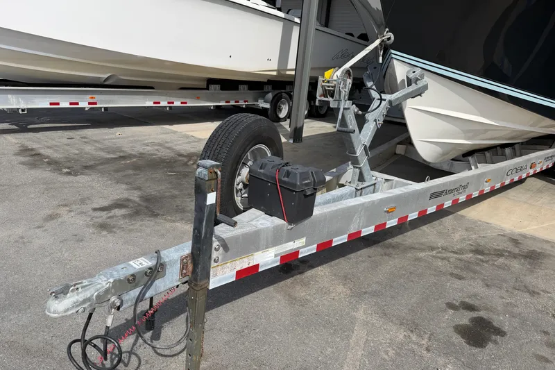 Slide: The Image of 2015 Cobia 344 Center Console boat on trailer, parked outdoors. - 9