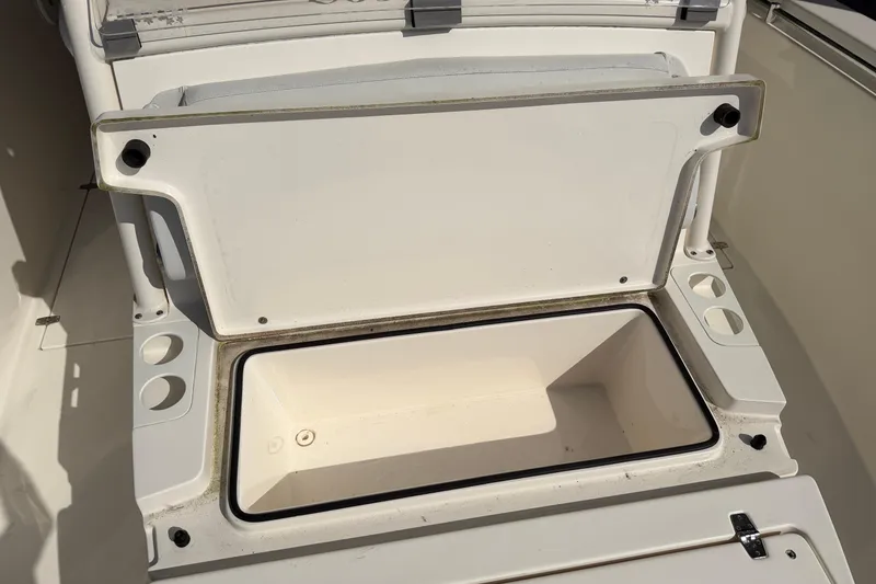 Slide: The Image of Open storage compartment on 2015 Cobia 344 Center Console boat. - 93