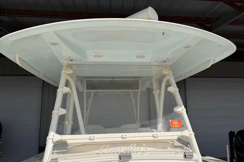 Slide: The Image of 2015 Cobia 344 Center Console boat under shelter, front view. - 94