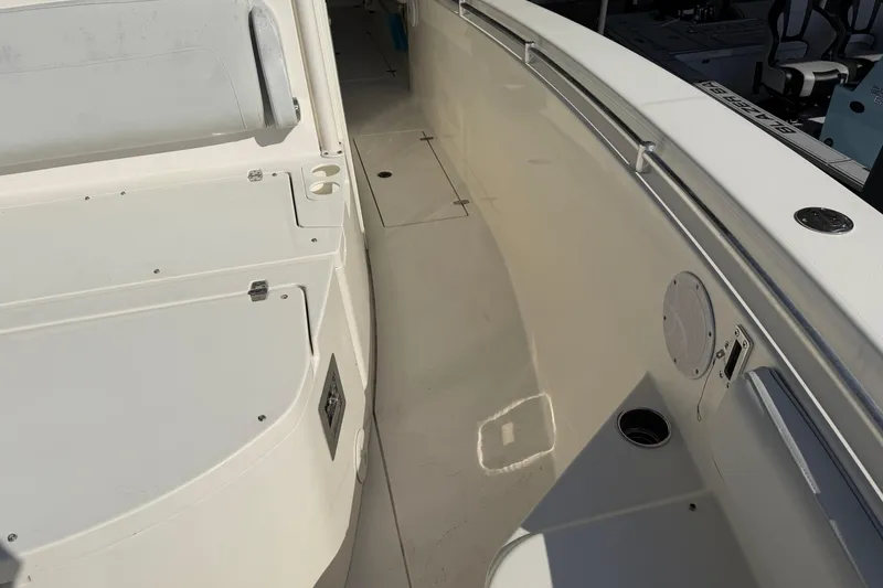 Slide: The Image of 2015 Cobia 344 Center Console boat interior with seating and storage compartments. - 95