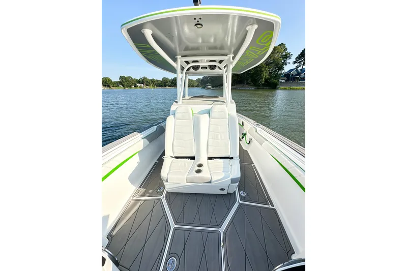 Slide: The Image of 2023 Statement 350 Open boat interior with white seating and sleek design on a calm lake. - 13