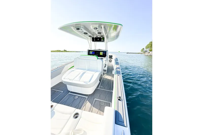 Slide: The Image of 2023 Statement 350 Open boat interior with sleek seating and advanced navigation system on calm water. - 17