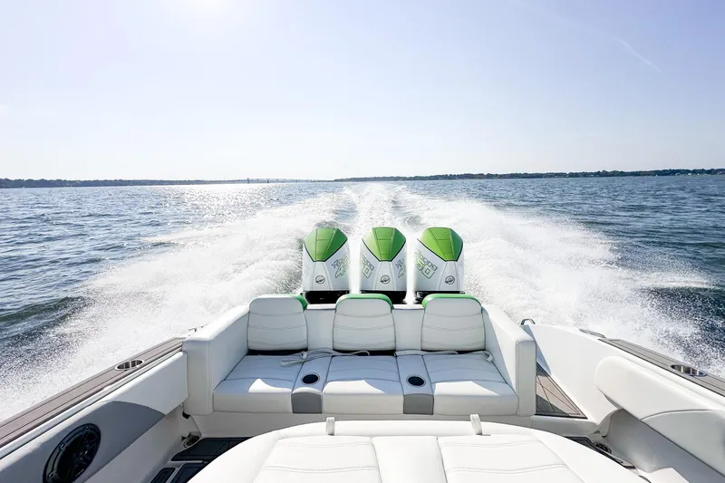 Slide: The Image of 2023 Statement 350 Open boat cruising on open water with triple engines. - 18