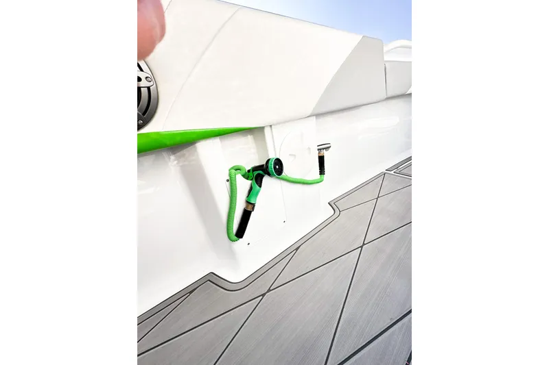 Slide: The Image of 2023 Statement 350 Open boat deck with green hose and sleek design. - 28