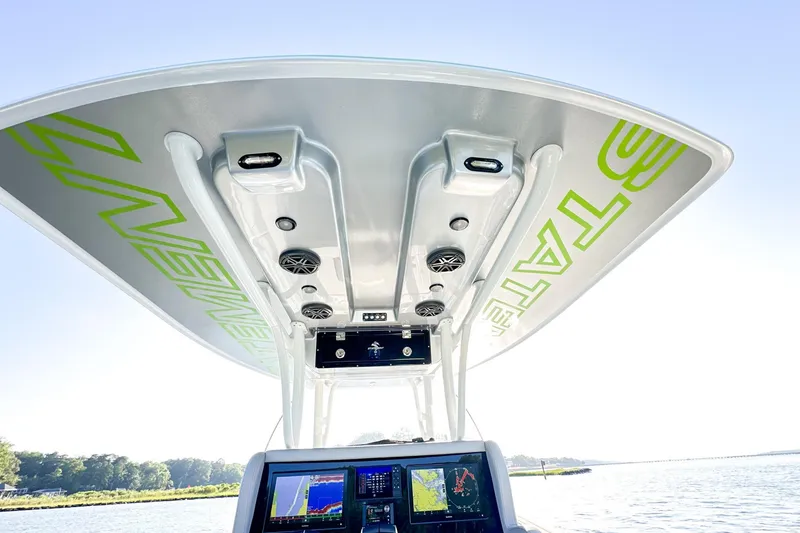 Slide: The Image of 2023 Statement 350 Open boat console with advanced navigation displays and overhead speakers. - 8