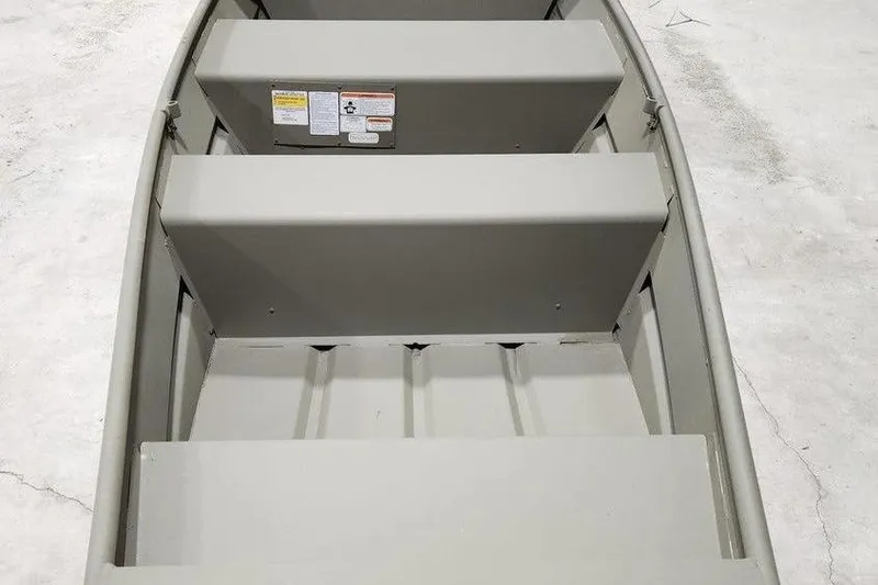 Slide: The Image of 2026 Tracker Grizzly 10 Jon boat interior with bench seats, viewed from above. - 4