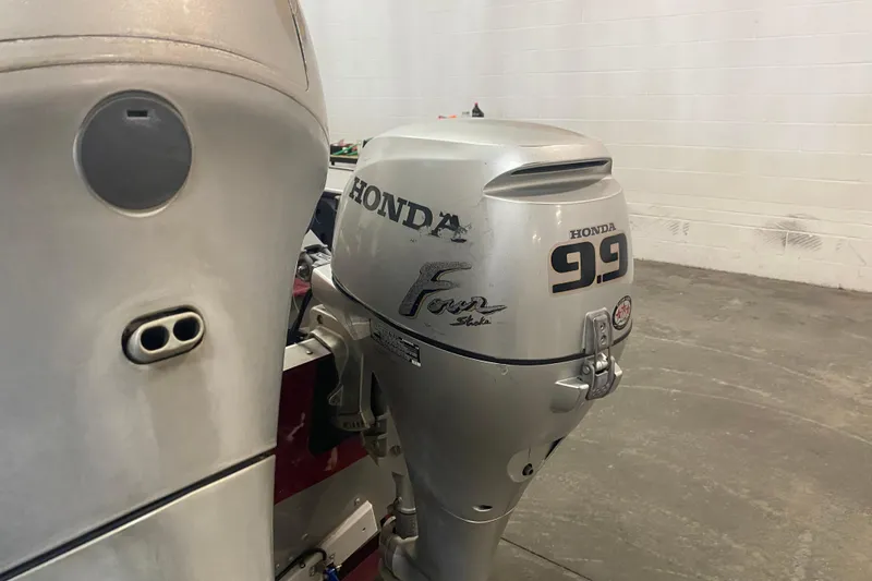 Slide: The Image of Honda 9.9 outboard motor on 2001 Lund 1900 Pro-V SE boat in garage. - 14