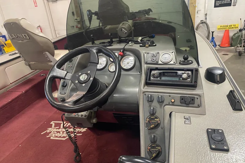 Slide: The Image of 2001 Lund 1900 Pro-V SE boat dashboard with steering wheel and control panel. - 15