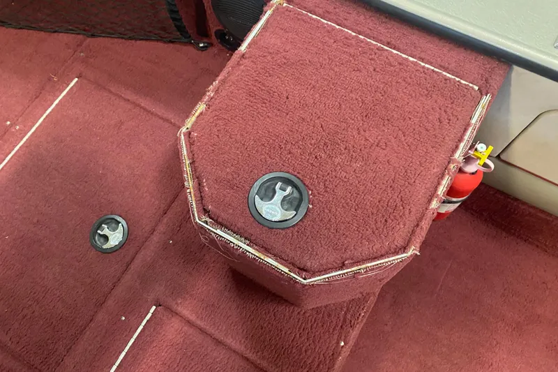 Slide: The Image of Red carpeted interior of a 2001 Lund 1900 Pro-V SE boat with storage compartments. - 5