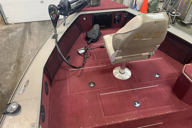Slide: The Image of 2001 Lund 1900 Pro-V SE boat interior with red carpet and swivel seat. - 6
