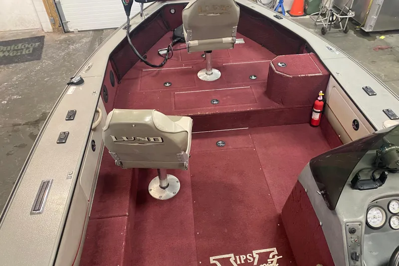 Slide: The Image of 2001 Lund 1900 Pro-V SE boat interior with red carpet and two swivel seats. - 7