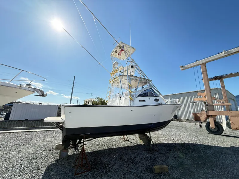 Slide: The Image of 2001 Albemarle 280 Express Sport Fisherman boat on dry dock under clear blue sky. - 1