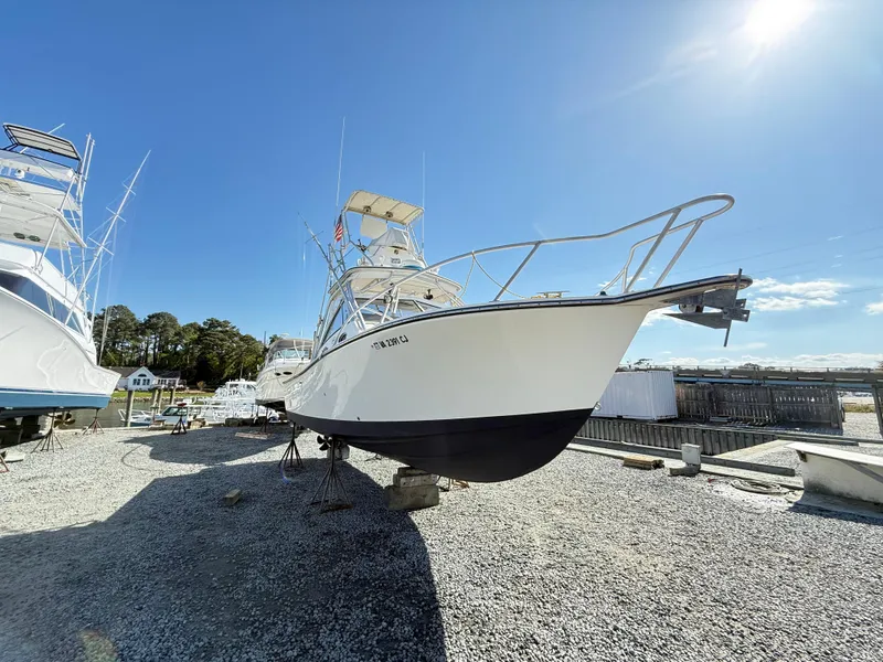 Slide: The Image of 2001 Albemarle 280 Express Sport Fisherman boat on dry dock under clear blue sky. - 2