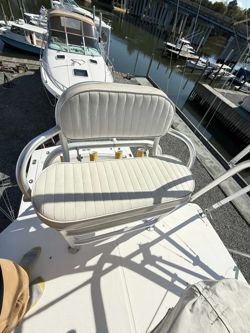 Slide: The Image of 2001 Albemarle 280 Express Sport Fisherman boat with white cushioned seating, docked near other boats. - 21