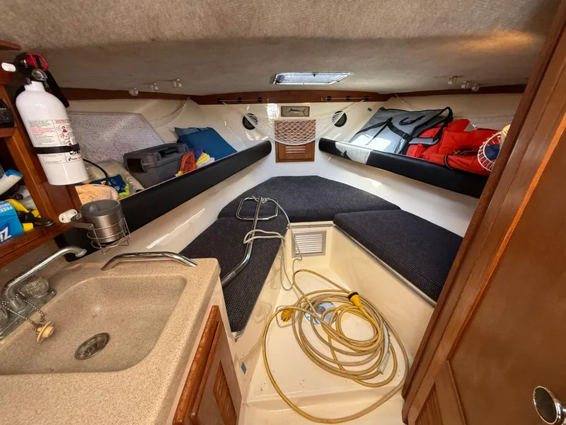 Slide: The Image of 2001 Albemarle 280 Express Sport Fisherman cabin with sink, storage, and seating. - 23