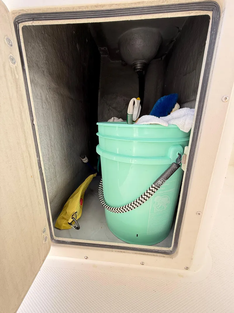 Slide: The Image of Storage compartment on a 2001 Albemarle 280 Express Sport Fisherman with cleaning supplies. - 37