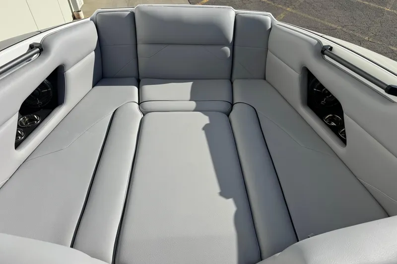 Slide: The Image of 2026 Moomba Mojo boat interior with spacious gray seating and cup holders. - 7