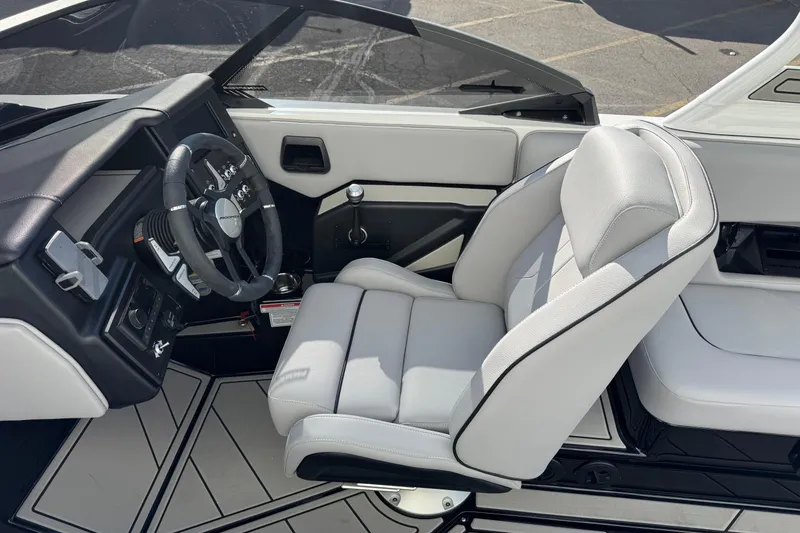 Slide: The Image of 2026 Moomba Mojo boat interior with sleek steering wheel and comfortable seating. - 8