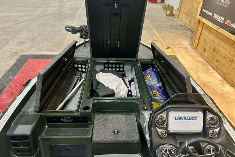 Slide: The Image of Interior of 2026 Triton 19 TrX boat with Lowrance electronics and storage compartments. - 11