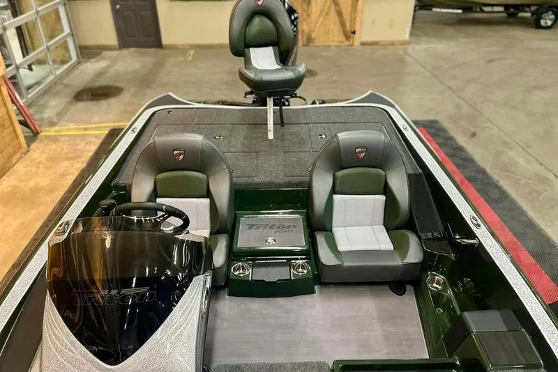 Slide: The Image of 2026 Triton 19 TrX boat interior with dual seats and steering console. - 12