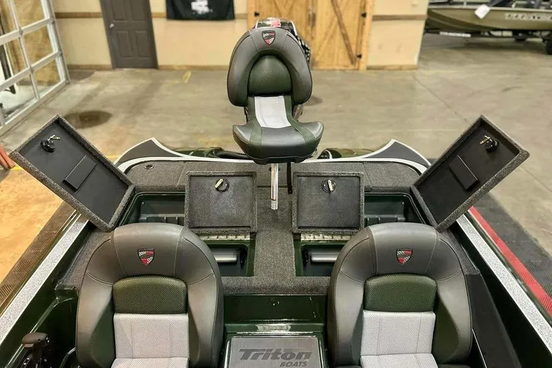 Slide: The Image of 2026 Triton 19 TrX boat interior with open storage compartments and seating. - 17
