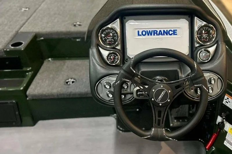 Slide: The Image of 2026 Triton 19 TrX boat dashboard with Lowrance display and steering wheel. - 3