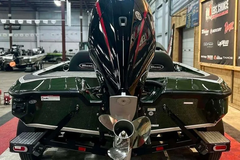 Slide: The Image of 2026 Triton 19 TrX boat in showroom, rear view with motor and propeller. - 4