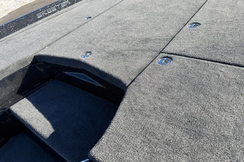 Slide: The Image of Carpeted deck of 2026 Skeeter ZXE21 boat with storage compartments. - 23