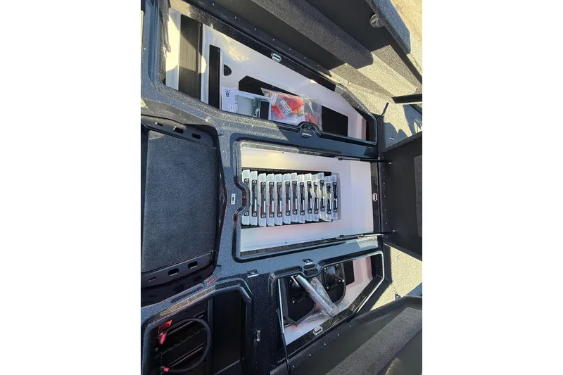 Slide: The Image of 2026 Skeeter ZXE21 boat storage compartments with organized tackle boxes and equipment. - 25