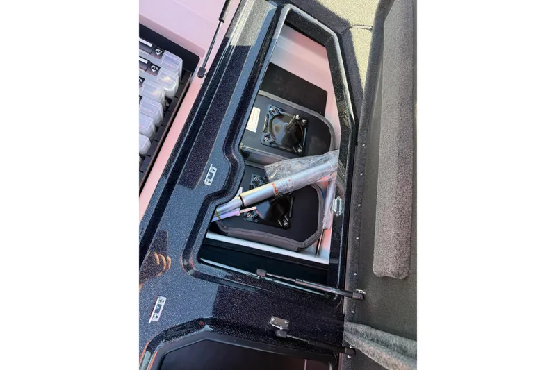 Slide: The Image of 2026 Skeeter ZXE21 boat storage compartment with organized fishing gear. - 27