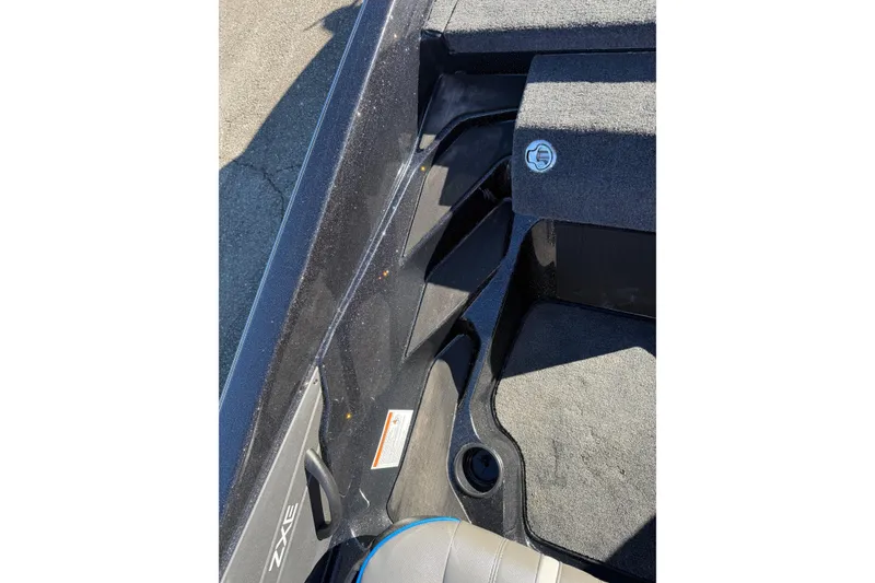 Slide: The Image of 2026 Skeeter ZXE21 boat interior with carpeted flooring and storage compartment. - 32