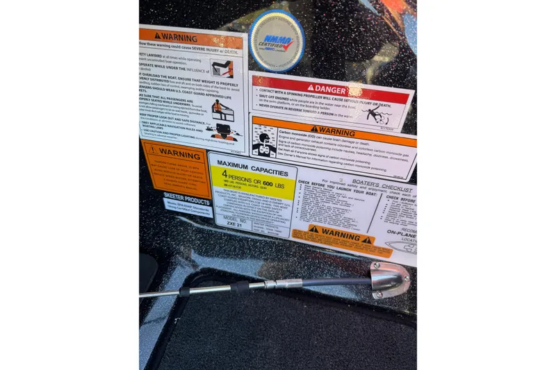 Slide: The Image of Warning labels on a 2026 Skeeter ZXE21 boat, detailing safety and capacity information. - 33